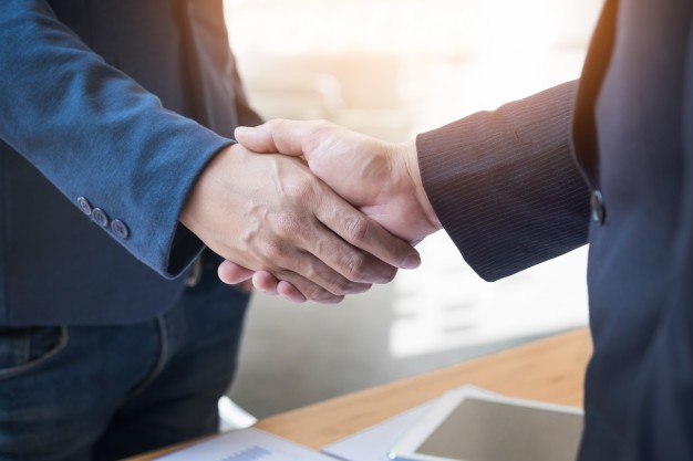 UT Democrats two confident business man shaking hands during a meeting in the office success dealing greeting and partner concept